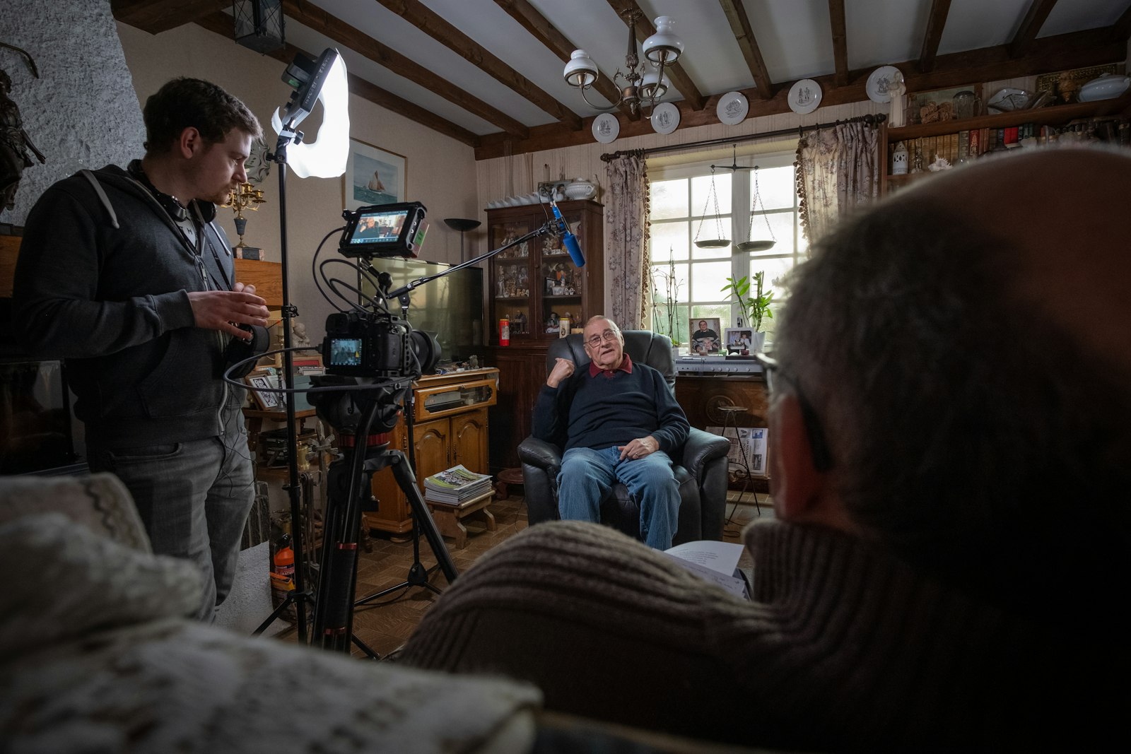 An elder being interviewed on camera at home